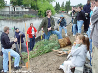 Photo of a County employee talking to a group of residents.